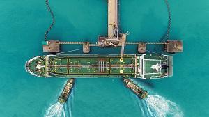Tug boats drag oil ship tanker to port for transfer of crude oil to oil refinery resized.jpg